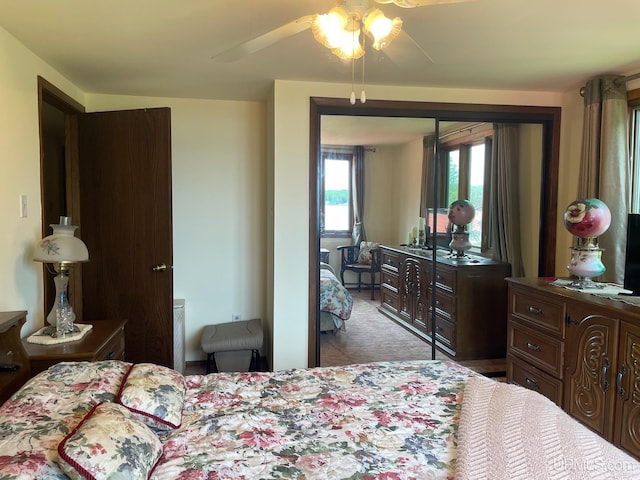 bedroom featuring a ceiling fan, access to outside, and light carpet