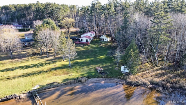 bird's eye view with a wooded view