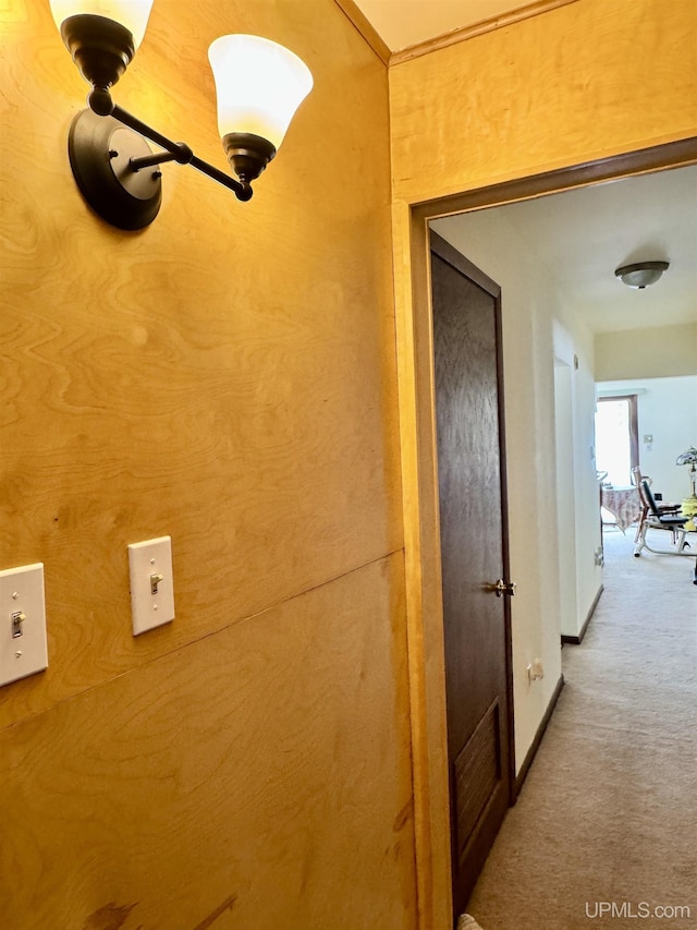 hall featuring carpet floors and baseboards