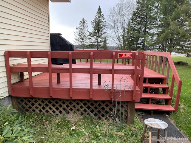 wooden deck with a grill