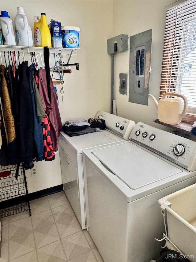 laundry area with laundry area, electric panel, and washer and clothes dryer