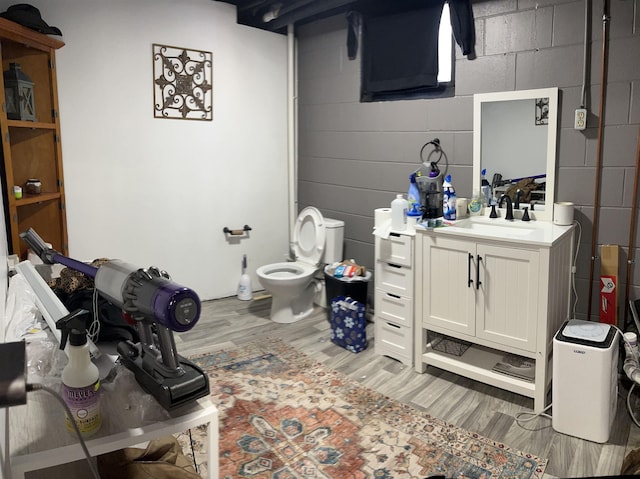 bathroom featuring vanity, wood-type flooring, and toilet