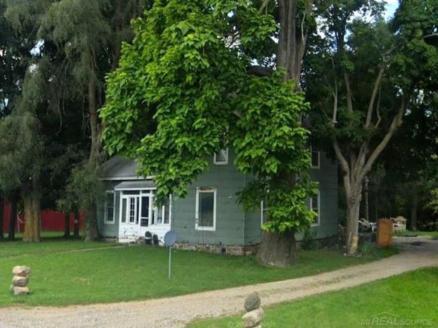 rear view of house featuring a yard