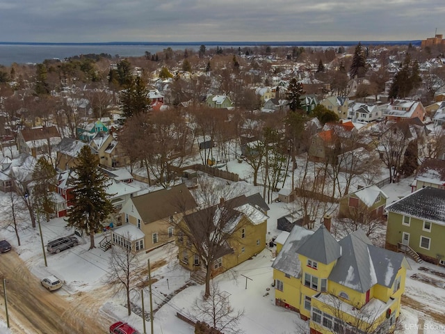 snowy aerial view featuring a residential view