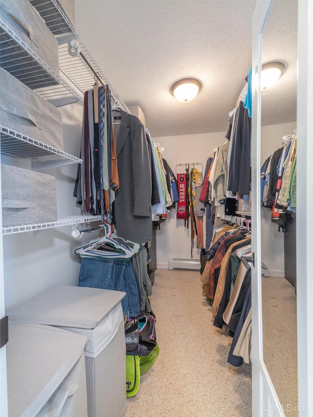 spacious closet with a baseboard radiator