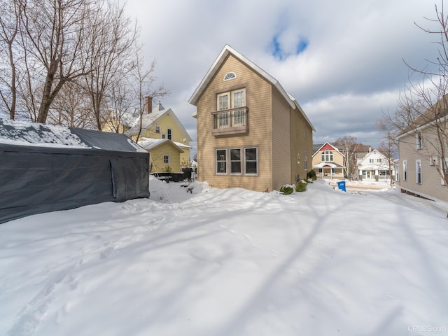 snow covered property featuring a residential view