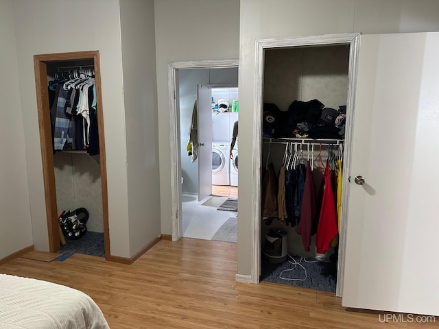 bedroom with a walk in closet, washer and dryer, light wood-type flooring, and a closet