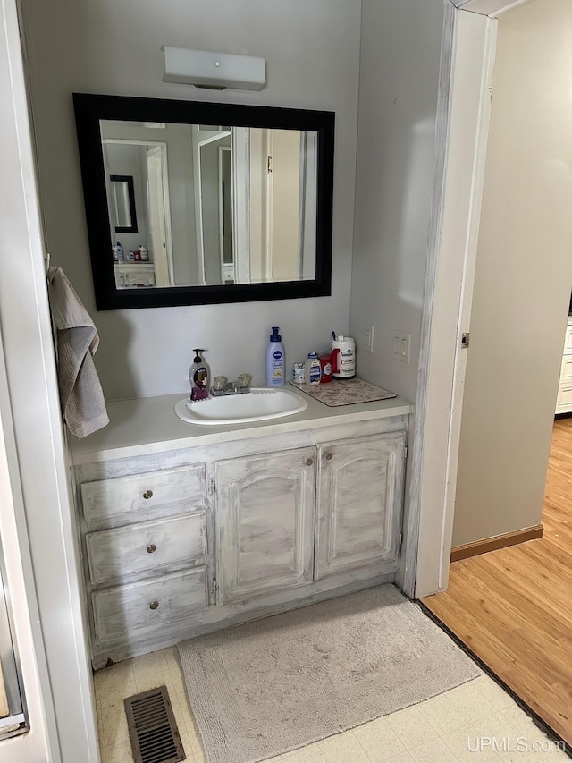 bathroom with vanity and wood-type flooring