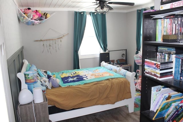 bedroom with crown molding and dark hardwood / wood-style flooring