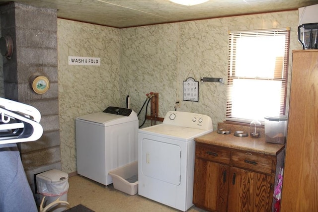 laundry room with cabinets and separate washer and dryer