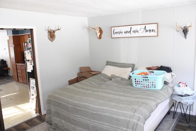 bedroom with dark wood-type flooring