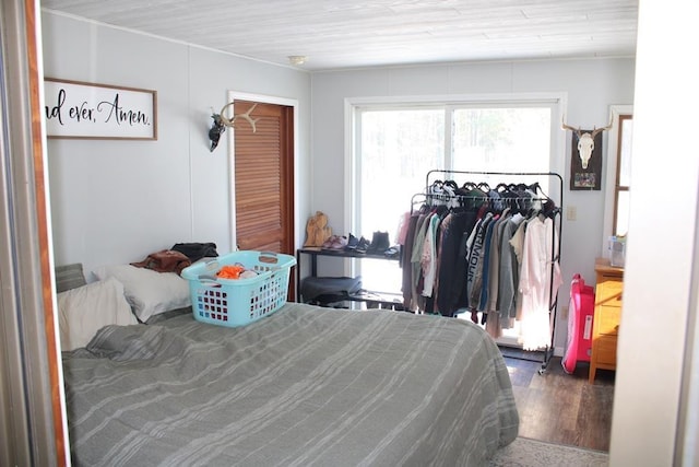 bedroom with dark wood-type flooring