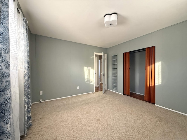 empty room featuring a healthy amount of sunlight and carpet floors