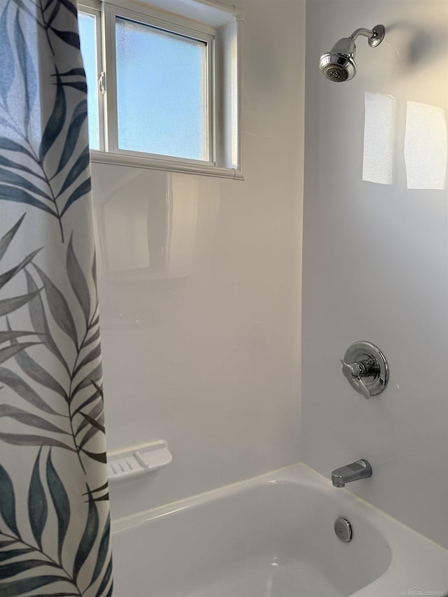 bathroom with shower / bathtub combination with curtain