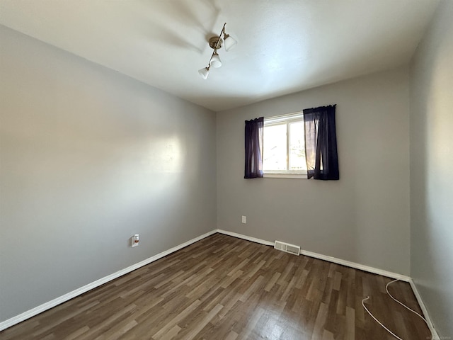 empty room featuring dark wood-type flooring