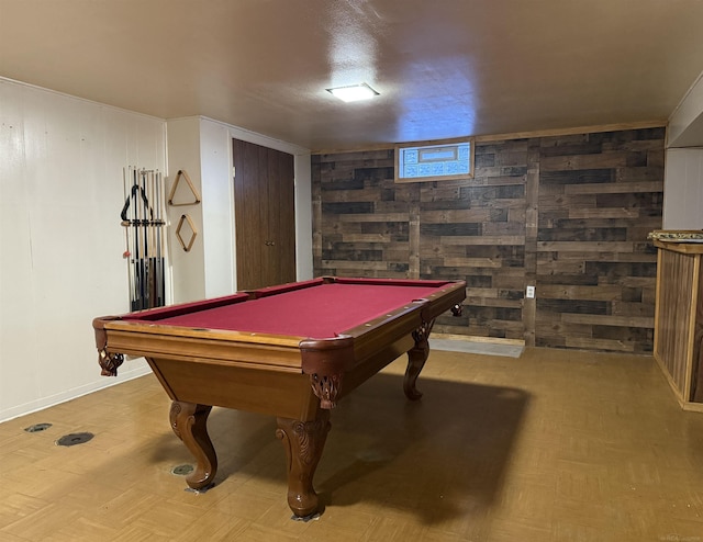 playroom with pool table and wooden walls