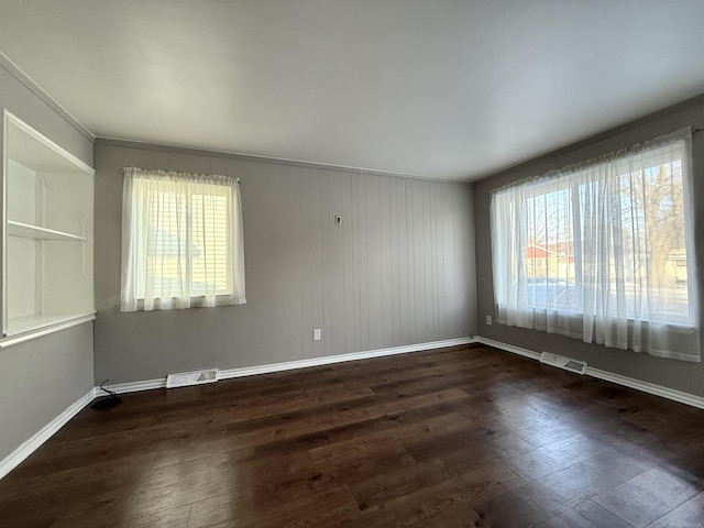 empty room with dark wood-type flooring