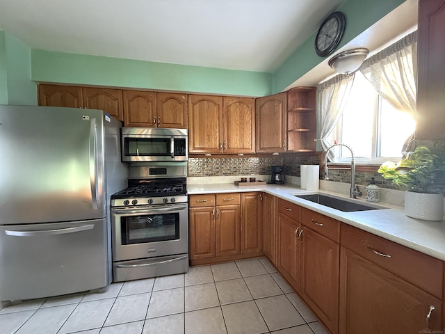 kitchen with stainless steel appliances, light tile patterned flooring, sink, and backsplash