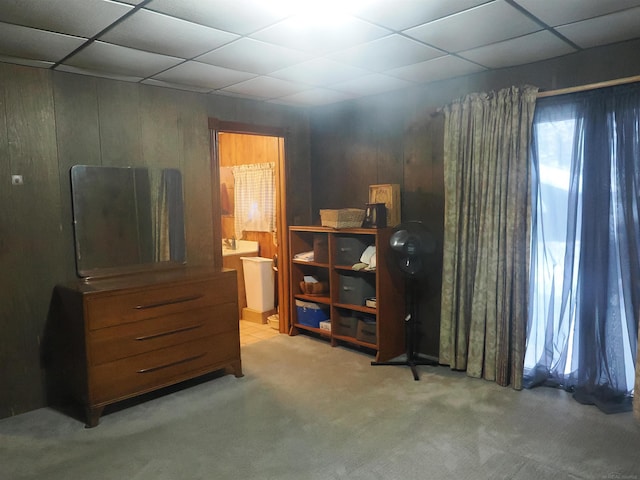 bedroom featuring carpet, connected bathroom, and a paneled ceiling