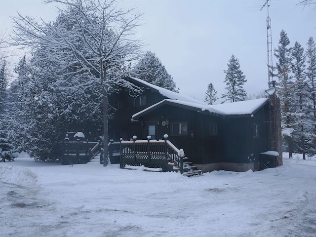 view of snowy property featuring a deck