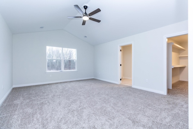 interior space featuring lofted ceiling, light carpet, and ceiling fan