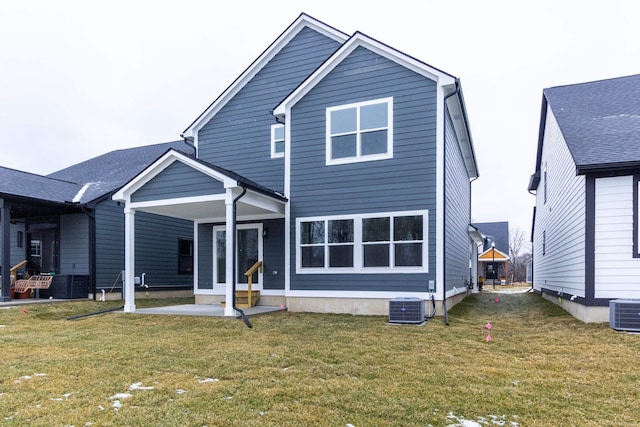 back of house with a yard and central AC unit