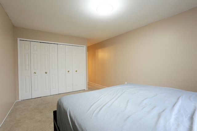 carpeted bedroom featuring a closet