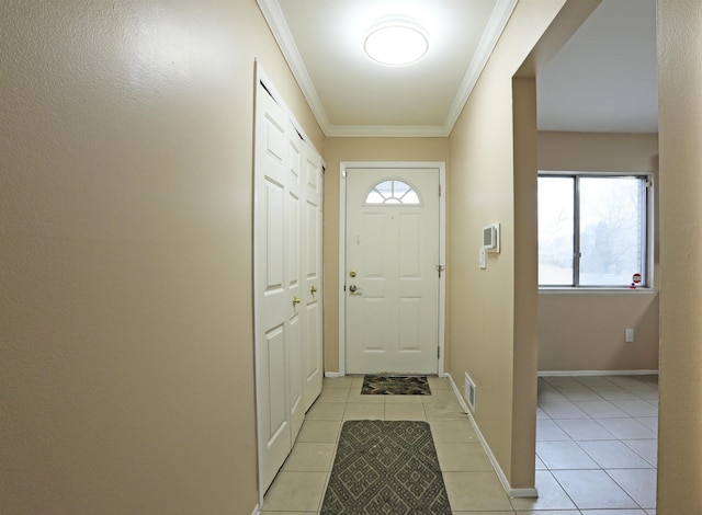 doorway with ornamental molding and light tile patterned floors