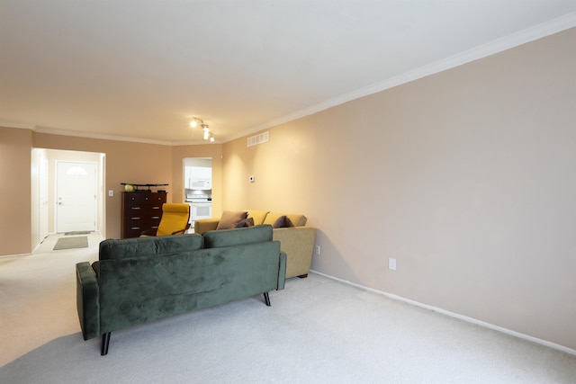 carpeted living area featuring baseboards, visible vents, and crown molding