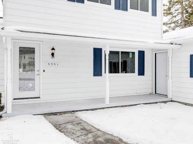 view of snow covered property entrance