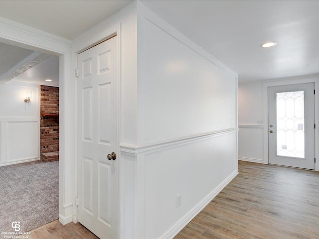 corridor with light hardwood / wood-style floors