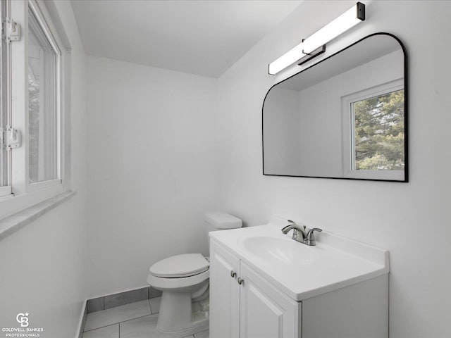 bathroom featuring vanity, tile patterned flooring, and toilet