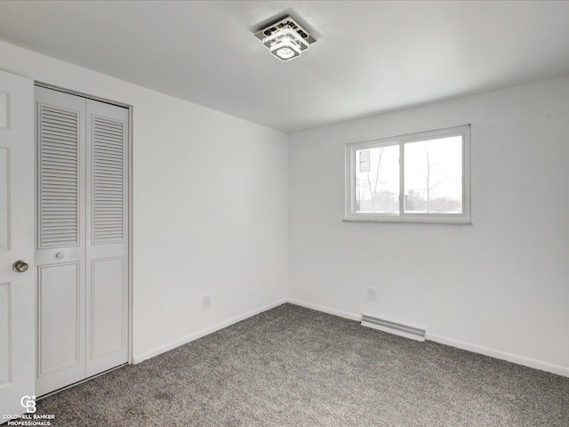 unfurnished bedroom featuring carpet floors and a closet