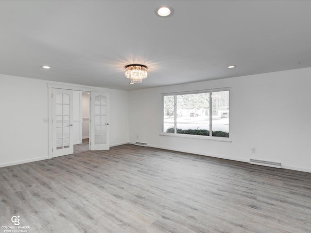 unfurnished room with french doors and light hardwood / wood-style floors