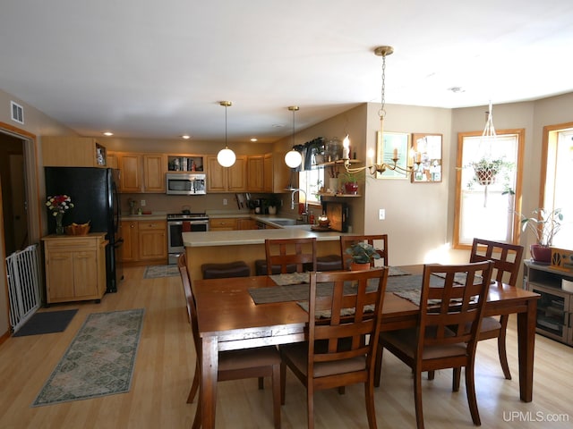 dining room with sink and light wood-type flooring