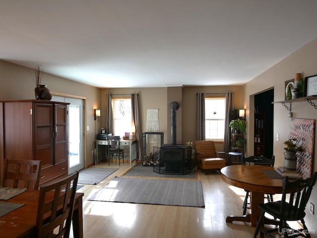 living room featuring light hardwood / wood-style floors and a wood stove