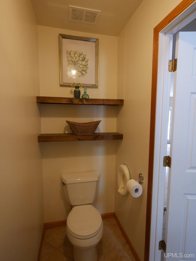 bathroom with toilet and tile patterned flooring