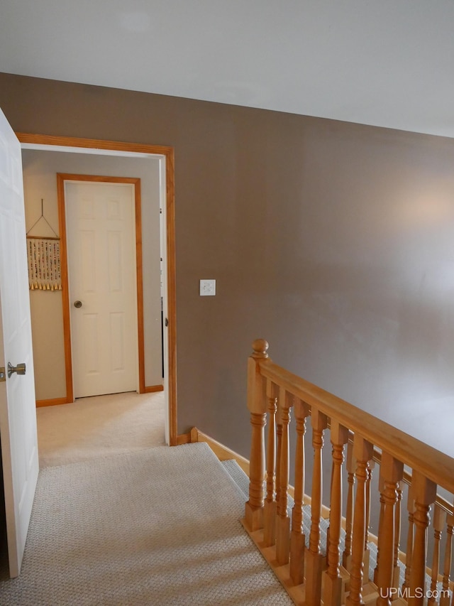 hallway with light colored carpet