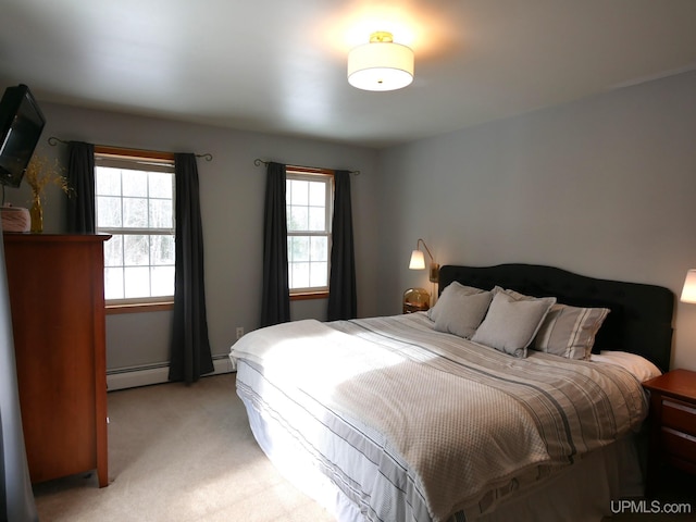 bedroom featuring light carpet and baseboard heating