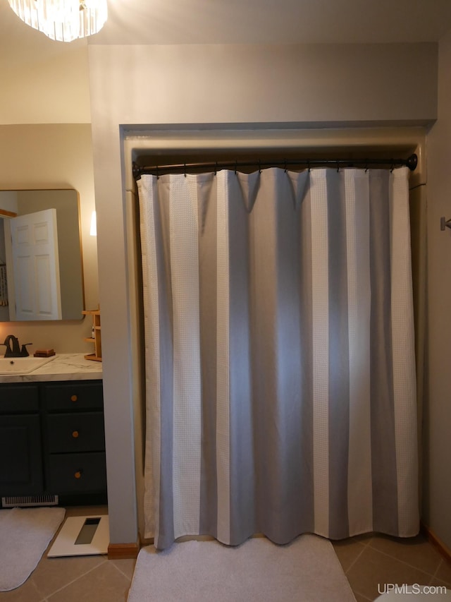 bathroom featuring tile patterned flooring and vanity