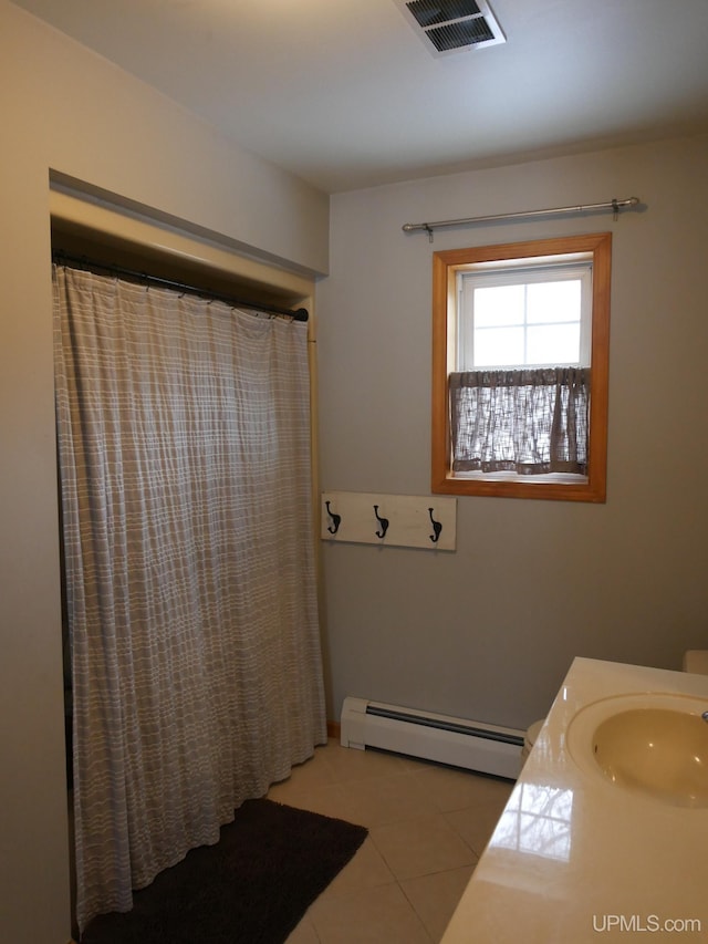 bathroom featuring vanity, tile patterned flooring, and a baseboard heating unit