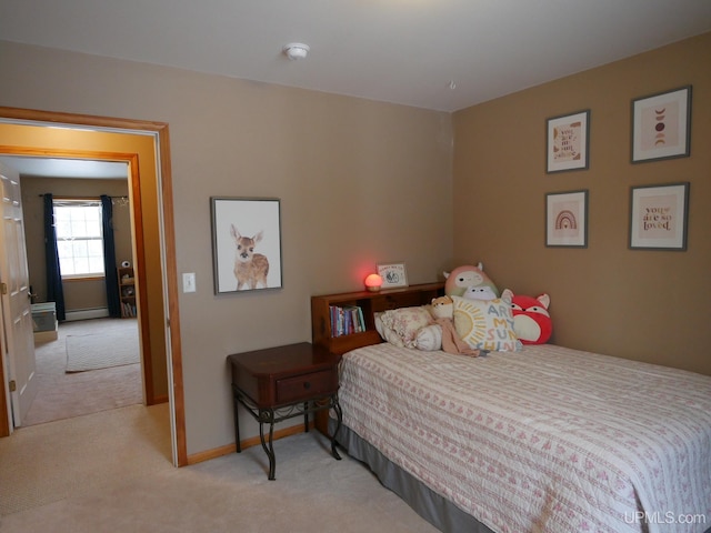 carpeted bedroom featuring baseboard heating