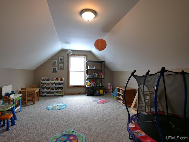 recreation room with vaulted ceiling and carpet