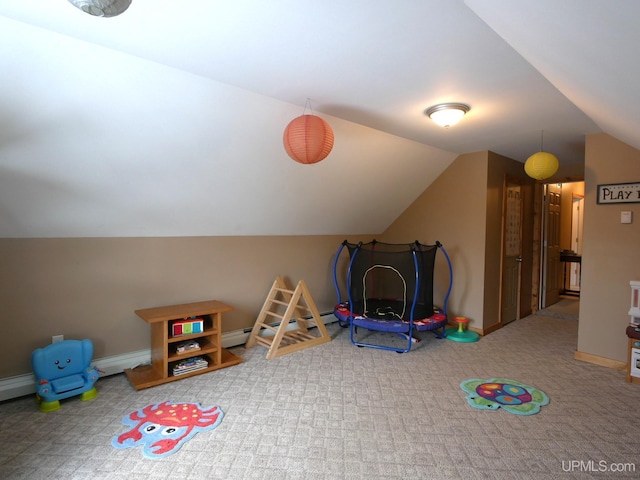 playroom featuring a baseboard heating unit, vaulted ceiling, and carpet