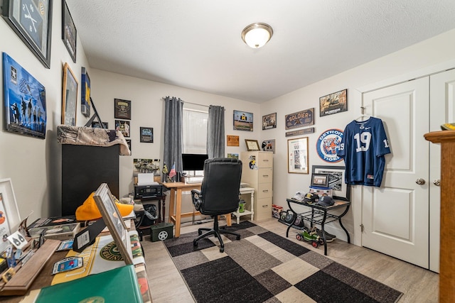 office space with light hardwood / wood-style flooring and a textured ceiling