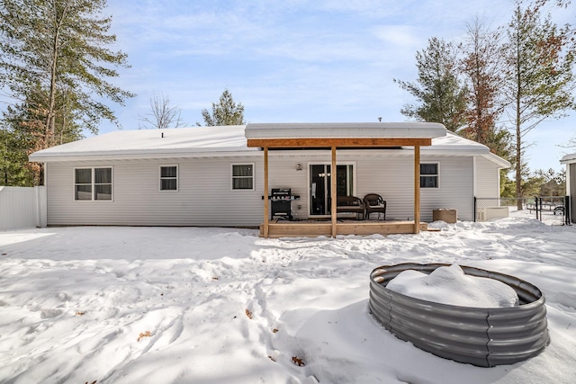 snow covered house with covered porch