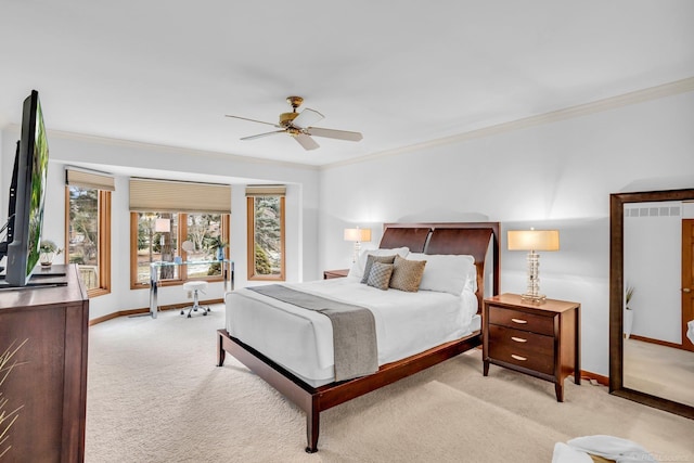 bedroom with ornamental molding, light colored carpet, and ceiling fan