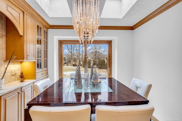 dining area with a notable chandelier, crown molding, and a textured ceiling