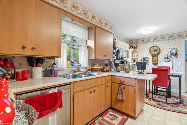 kitchen featuring sink, stainless steel dishwasher, and kitchen peninsula