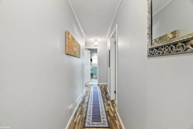 hall featuring dark wood-type flooring and ornamental molding